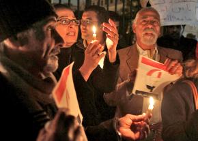 Demonstrators gather for a vigil following the burning of a Coptic church in Cairo